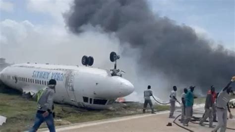 Passenger plane flips on its back as it crash-lands at international airport in Somalia | World ...