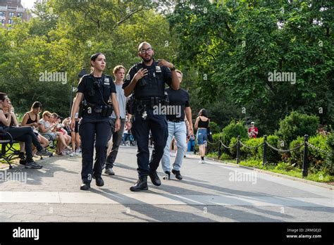 New York, USA - July 21st, 2023: Two police officers patrol the Washington square park Stock ...