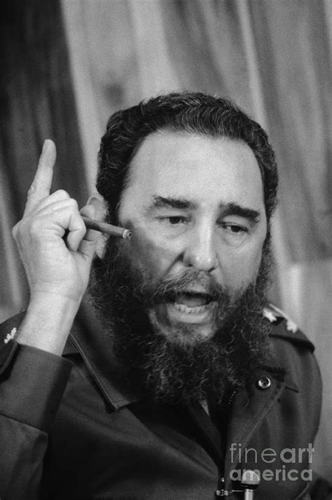 Fidel Castro Smoking A Cigar by Bettmann