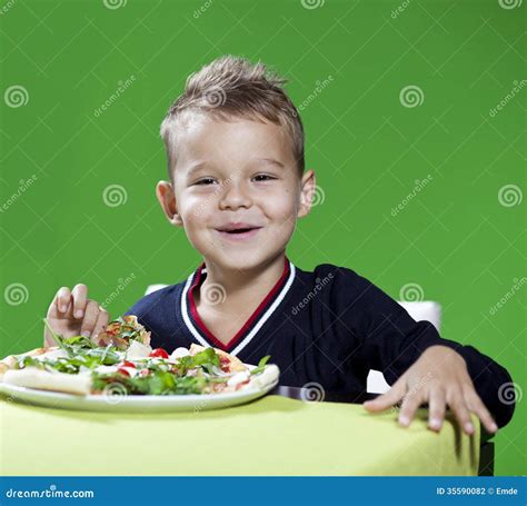 Boy Eating Pizza stock photo. Image of food, crust, excitement - 35590082