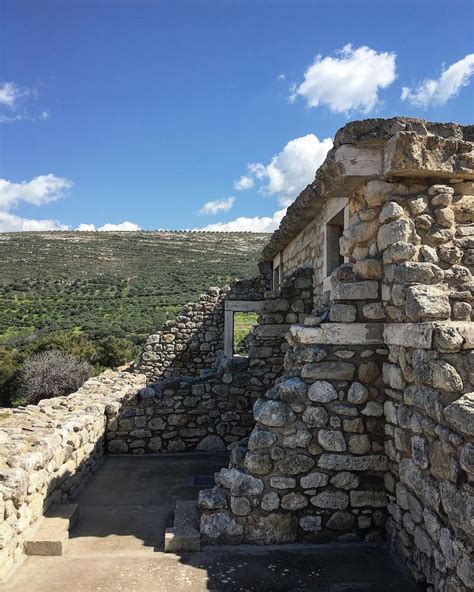 an old stone structure with steps leading up to it and the sky in the background