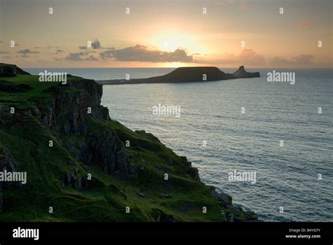 Sunset over Worms Head from Rhossili on the Gower Peninsula Stock Photo ...