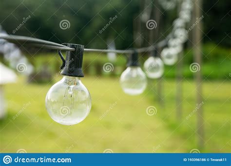 Outdoor String Light Bulbs Hanging on a Line Stock Photo - Image of ...