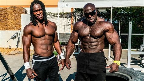 two muscular men standing next to each other