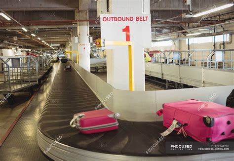 Luggage on the baggage carousel at airport terminal — red, anticipation - Stock Photo | #227244226