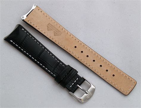 Black crocodile-style leather pin buckle strap with white stitching to ...