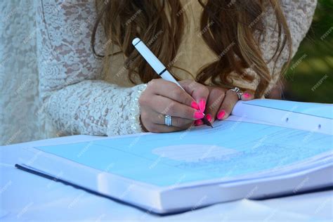 Premium Photo | Bride signing the marriage register book