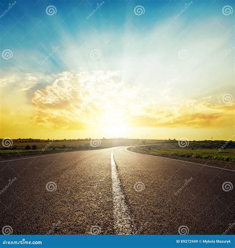 Asphalt Road To Horizon and Sunset in Clouds Stock Image - Image of ...