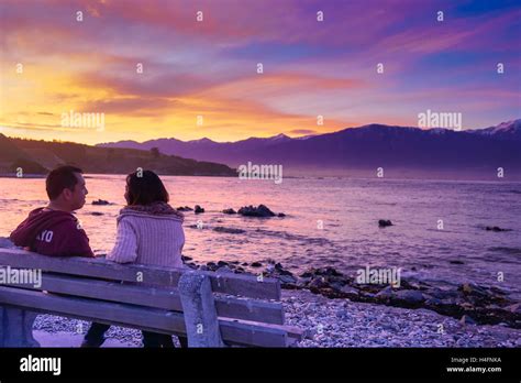 Couple sitting on the bench having a conversation under the sunset Stock Photo - Alamy