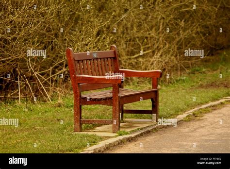 Empty park bench Stock Photo - Alamy