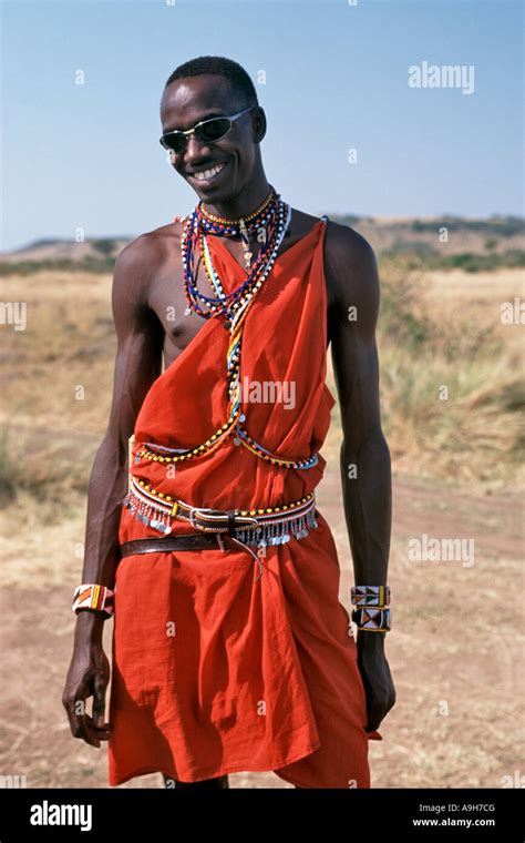 A Masai man in traditional outfit poses wearing sunglasses in the Masai ...