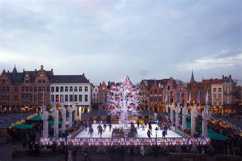 Markt square in Brugge (Bruges), Belgium in winter for Christmas. Lit up and ice rink view ...