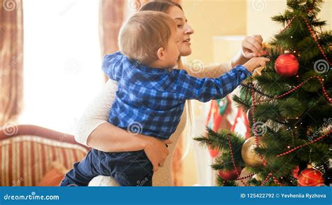 Toned Portrait of Little Toddler Boy Adorning Christmas Tree with Baubles Stock Photo - Image of ...