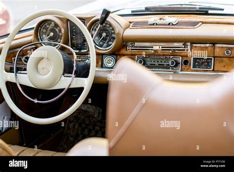 the interior of the Mercedes oldtimer in a beige and white color, covered with leather and wood ...