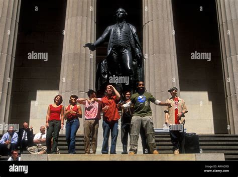 people on steps of Federal Hall National Memorial, statue of George ...