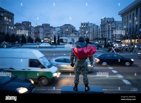 Kyiv, Ukraine - February 20, 2023: A military uniformed Ukrainian man waves the war flag at the ...