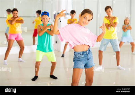 Group of children are learning dance moves in modern studio Stock Photo ...
