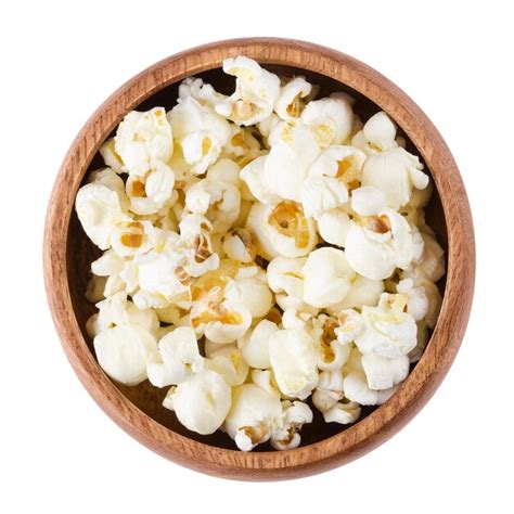 Premium Photo | Popped popcorn in a bowl over white