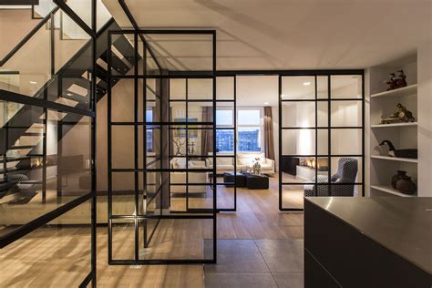 Black Framed Glass Doors Are A Prominent Feature Of This Apartment's Interior Design