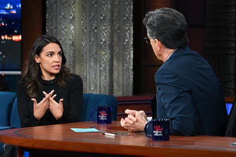 AOC Commands ‘Colbert’ Interview in Smart Floral Skirt & Block Heels – Footwear News