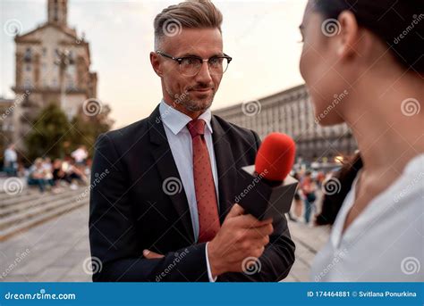 First. Best. Live. Professional Reporter Interviewing Woman on Urban ...