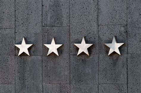 Four silver stars on a wall - PatternPictures