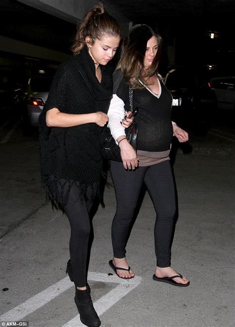 Selena Gomez keeps a protective hold of her pregnant mother on trip to ...