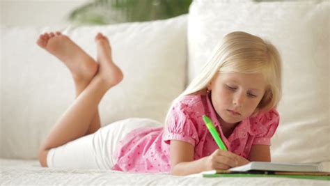 Cute Little Girl Lying On Sofa Writing In Notebook And Smiling Stock Footage Video 4647185 ...