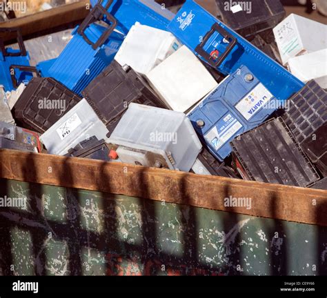 Vehicle batteries await recycling in scrap yard skip Stock Photo - Alamy