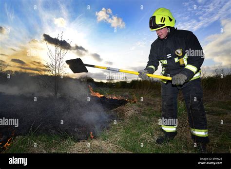 A firefighter putting out flames at a field fire. Picture: Scott Bairstow/Alamy Stock Photo - Alamy