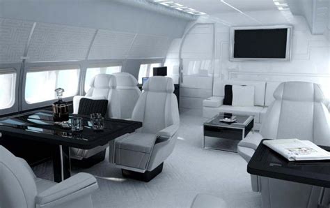the interior of an airplane with white leather seats and black table in ...