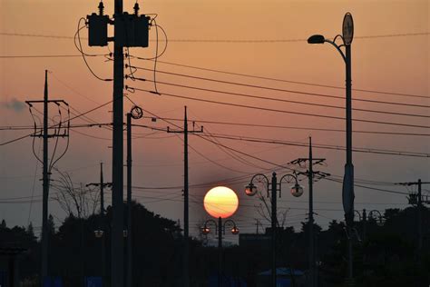 Electric Posts and Lampposts in the City During Sunset · Free Stock Photo