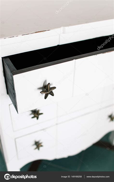 White vintage chest of drawers stands near white wall Stock Photo by ...