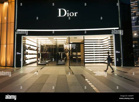 Singapore, Singapore, Orchard Road. Shoppers outside the Dior store at the ION Orchard Mall ...