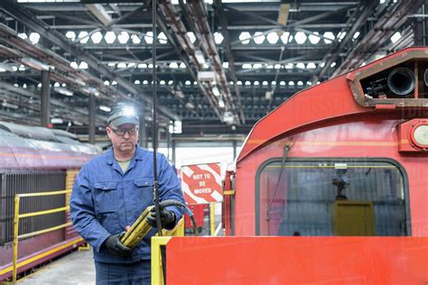 Locomotive engineer working in train works - Stock Photo - Dissolve