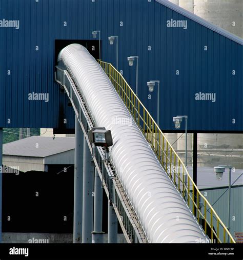 Covered conveyor belt mechanism transports raw materials in cement ...