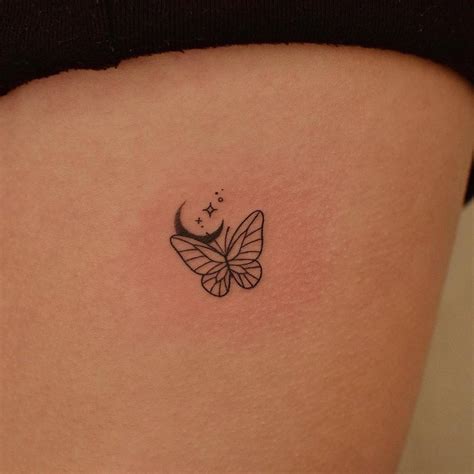 Simple butterfly and moon tattoo located on the rib.