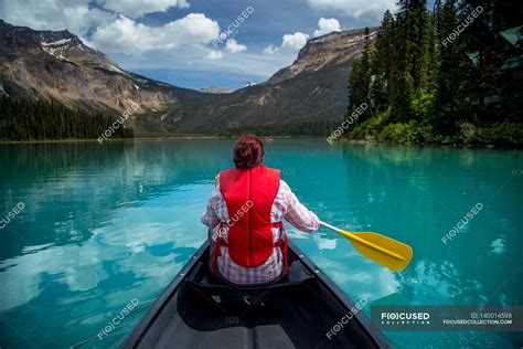 Woman canoeing in Emerald Lake — tranquil scene, river - Stock Photo ...