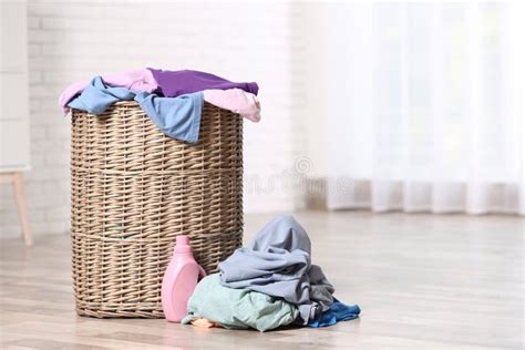 Wicker Laundry Basket with Dirty Clothes and Detergent on Floor Indoors Stock Image - Image of ...