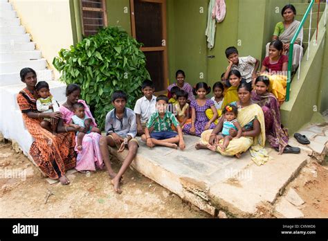 Group of indian villagers sitting outside an indian house in a rural ...