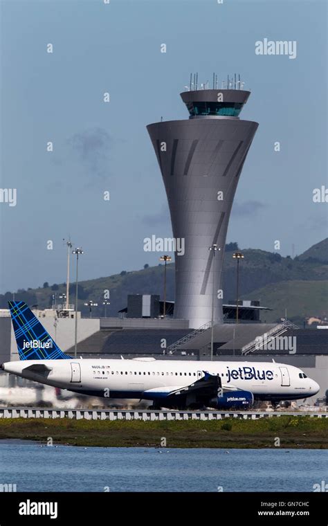 Jet Blue Airbus A320-232 (N606JB) passes the control tower on takeoff at San Francisco ...