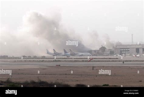 Smoke billows from inside the Jinnah International Airport, after suspected Islamic militants ...