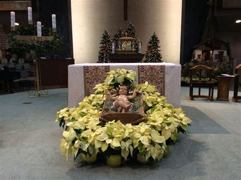 Altar decorated with baby Jesus and poinsettias for Christmas. Epiphany ...