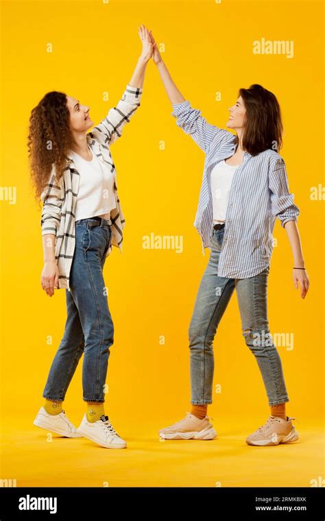 Front view friends giving high five Stock Photo - Alamy