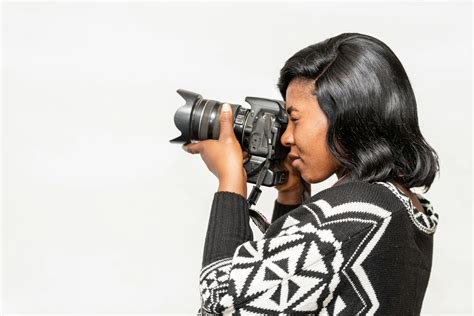 Black female photographer taking photo on camera · Free Stock Photo