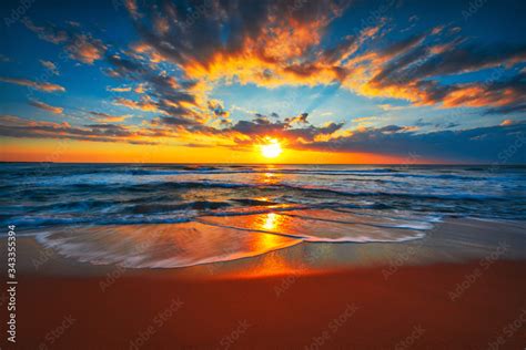 Sunrise on the beach and ocean waves on a tropical sea Stock Photo ...