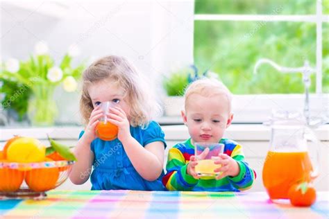 Kids drinking orange juice — Stock Photo © FamVeldman #105041364