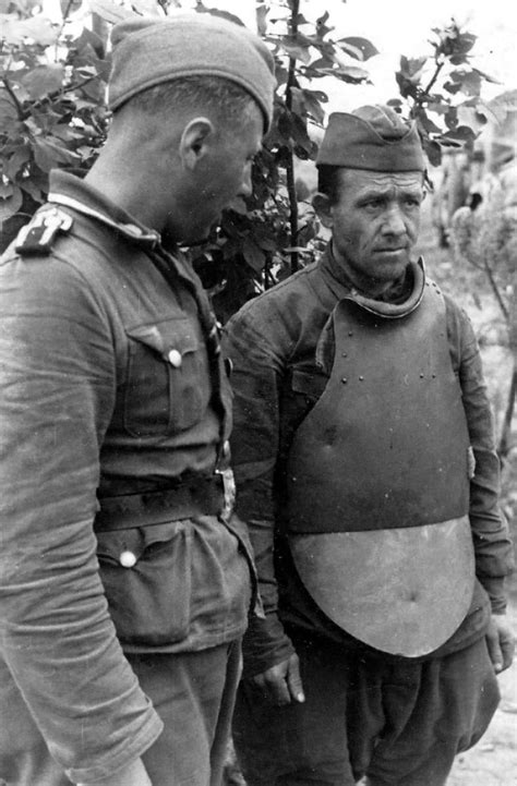 Soviet POW wearing steel plate body armor identified as "CH-42." Note the two dents apparently ...
