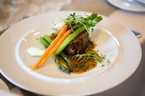 Cooked Meat With Vegetable Garnish on White Plate · Free Stock Photo