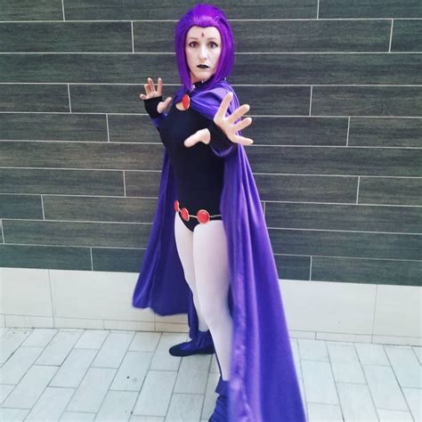 a woman dressed in purple and black posing for the camera with her ...